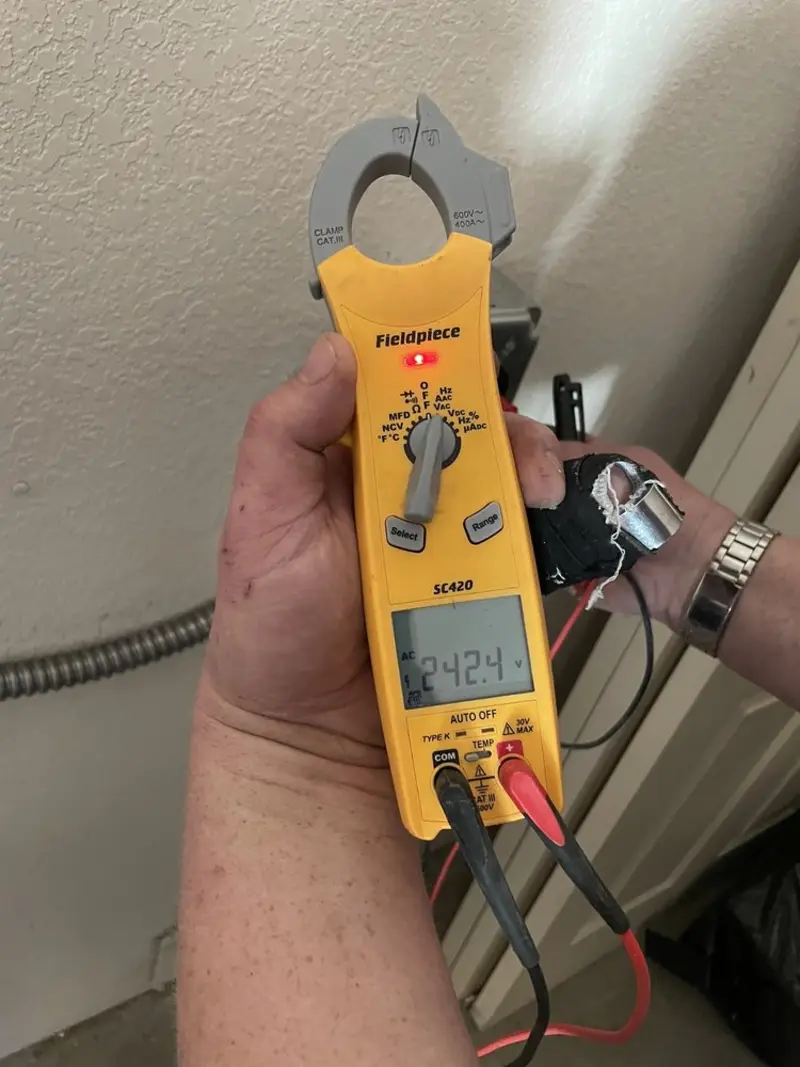 Voltage testing with clamp meter during Ceiling Fan Installation in West Mead
